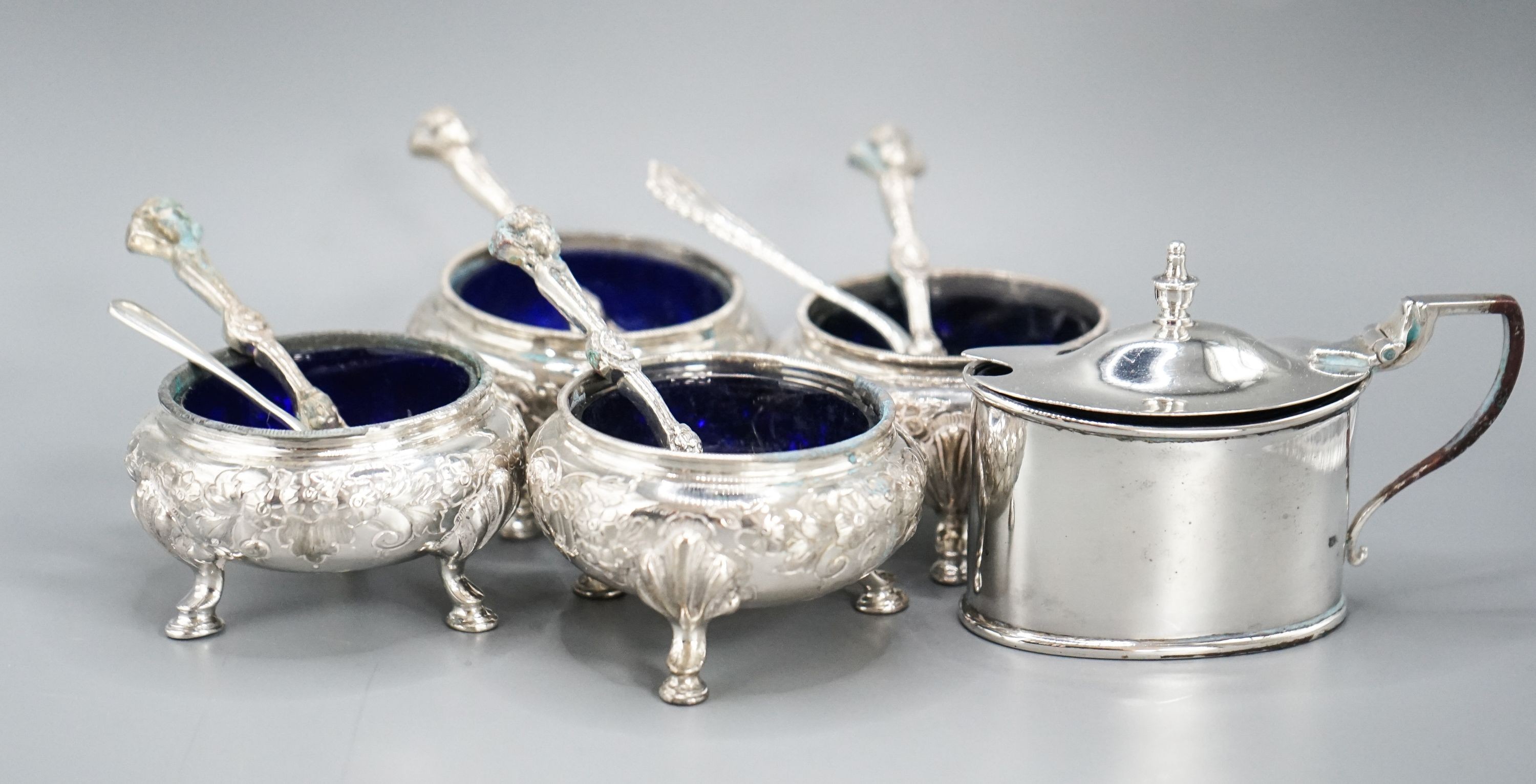 A set of four Victorian silver bun salts, Sheffield, 1869 and four associated silver spoons and a later silver mustard pot and two spoons.
